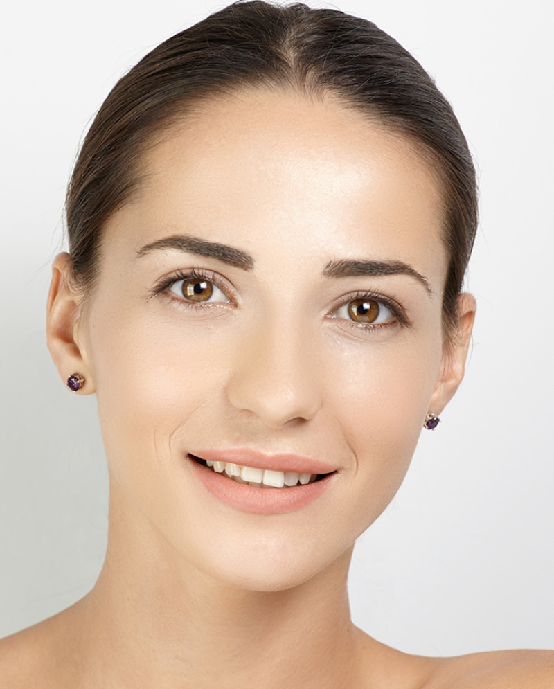 Brunette woman with brown eyes wearing earrings