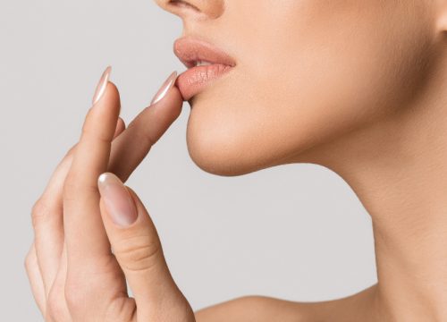Woman touching her thin lips