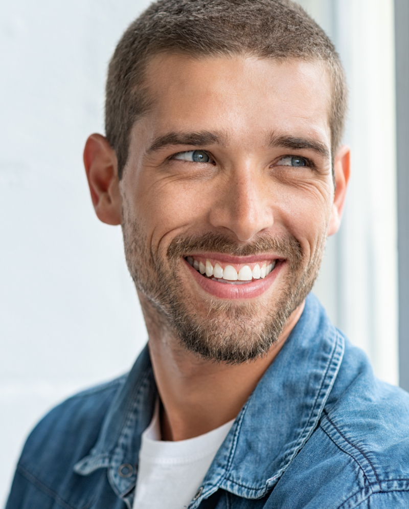 Smiling man wearing a denim shirt